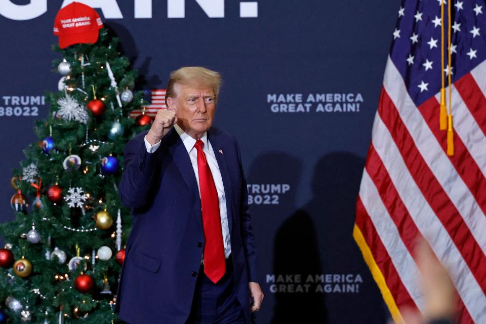 Former President and 2024 presidential hopeful Donald Trump gestures at the end of a campaign event in Waterloo, Iowa, on December 19, 2023.