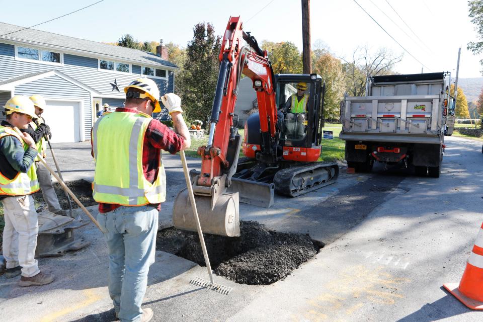 Workers with Central Hudson Gas and Electric Corp finish up hooking up a residence to a newly installed upgraded gas main in Cornwall on Oct. 31, 2018.