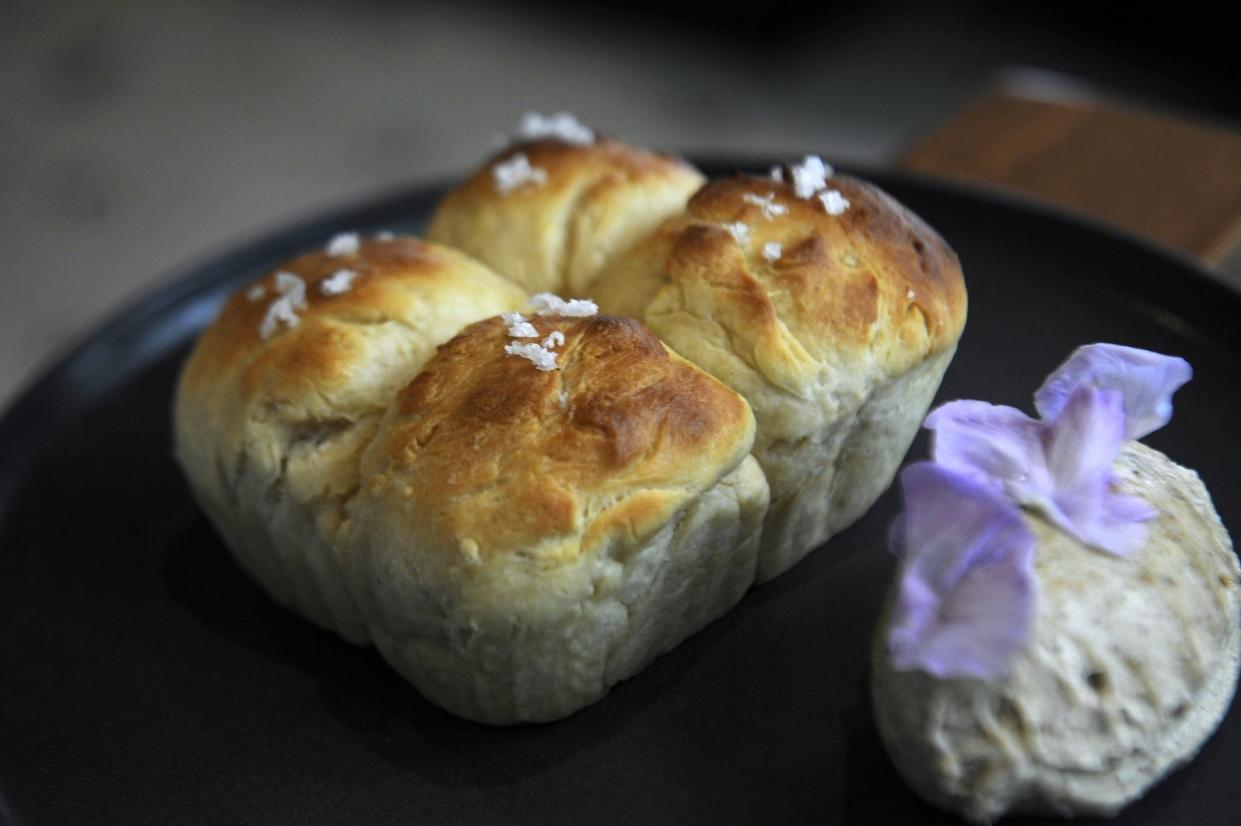 Rich, buttery parker house rolls are served with morel butter at Cosmos Bistro on Thursday, May 3, 2025