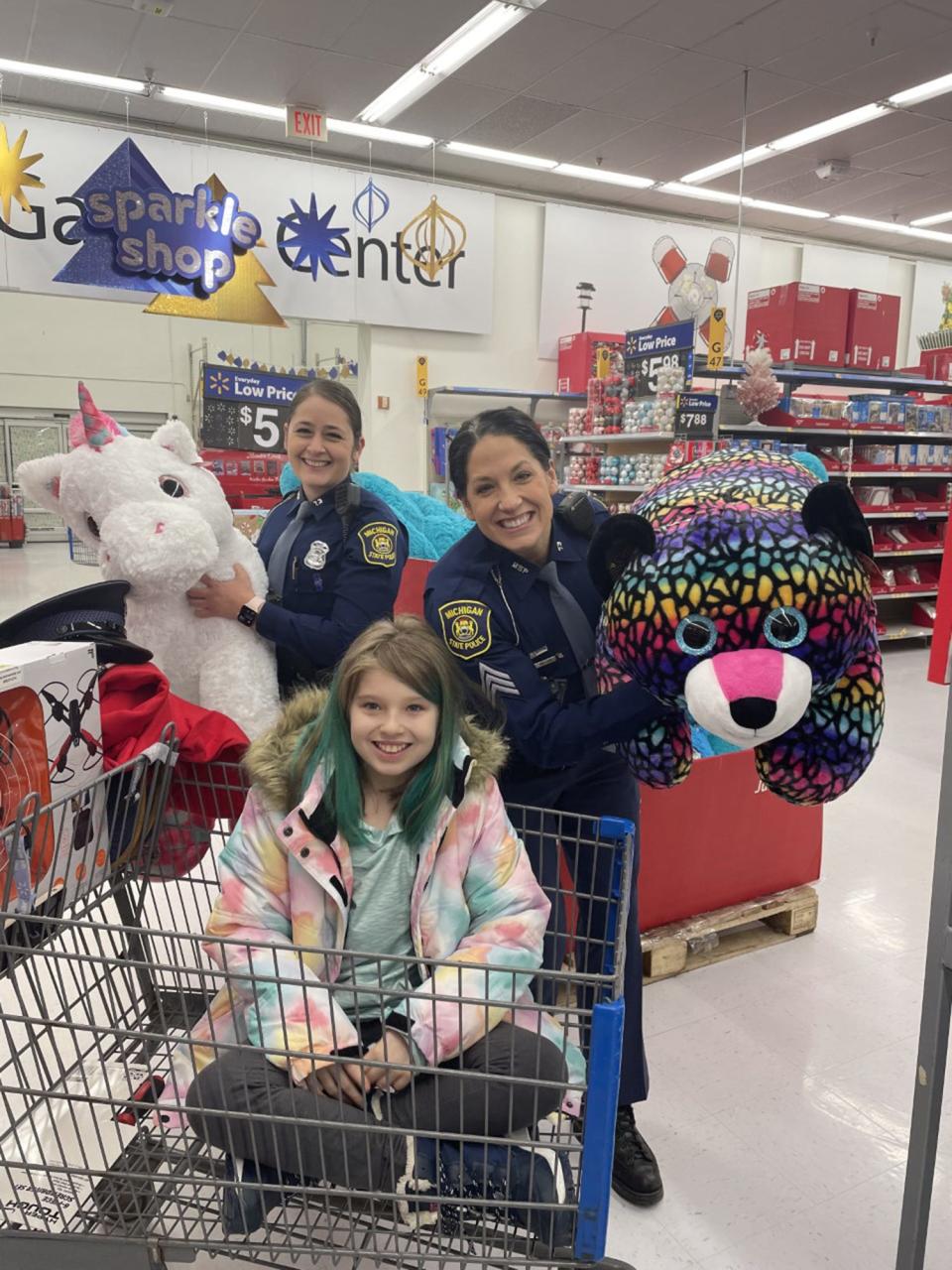 Nine-year-old Summer Lahaie shops with Michigan State Police troopers on Wednesday, Nov. 30 at the Walmart in Cheboygan.