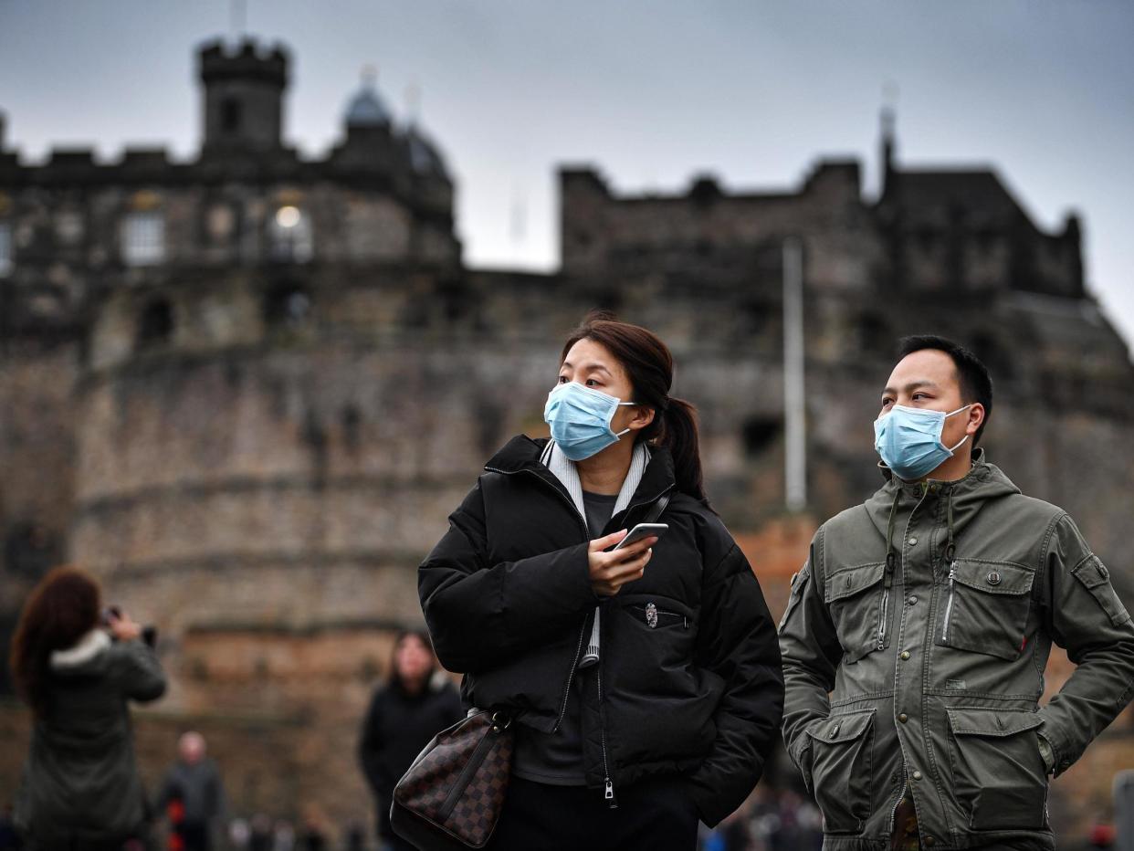 Tourists wear face masks as they visit Edinburgh Castle on 24 January, 2020: Getty