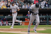 New York Yankees' Joey Gallo, left, scores as Aaron Hicks, right, heads to first base during the second inning of a baseball game against the Chicago White Sox in Chicago, Sunday, May 15, 2022. (AP Photo/Nam Y. Huh)