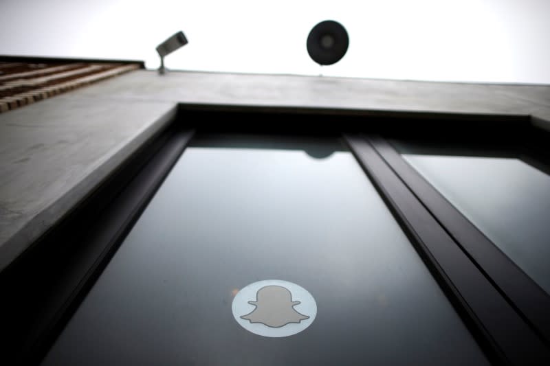 A security camera is seen over the door of Snapchat's headquarters in Venice, Los Angeles, California October 13, 2014. REUTERS/Lucy Nicholson/Files