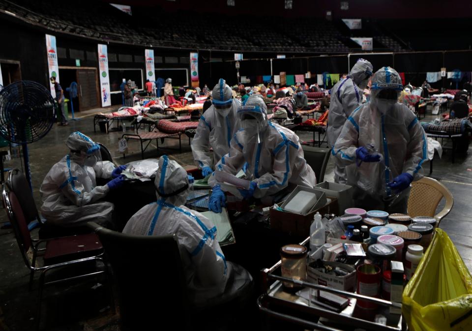 Doctors and nurses work in a Covid-19 insolation centre in India (AP)