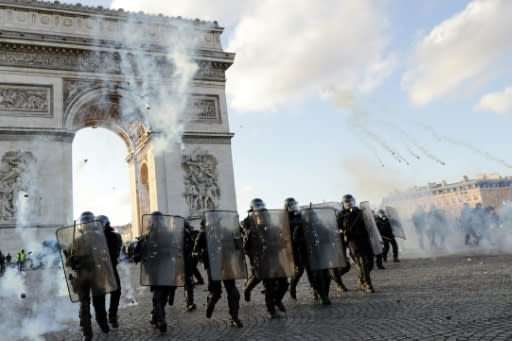 Riot police set up protective lines around the Arc de Triomphe