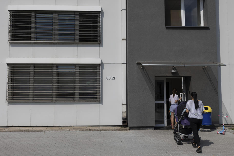 Ukrainian women enter a refugee shelter in Warsaw, Poland, Wednesday, Aug. 17, 2022. The global technology company Siemens has converted some of its offices in Warsaw into a refugee shelter for over 150 people who have fled the war in Ukraine. (AP Photo/Michal Dyjuk)