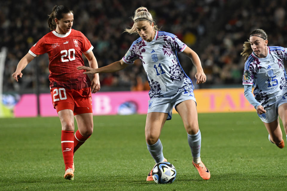 Spain's Alexia Putellas, battles for the ball with Switzerland's Fabienne Humm, left, during the Women's World Cup second round soccer match between Switzerland and Spain at Eden Park in Auckland, New Zealand, Saturday, Aug. 5, 2023. (AP Photo/Andrew Cornaga)