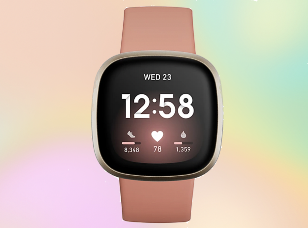 Fitbit versa 3 with a pink clay band and a rainbow background. 