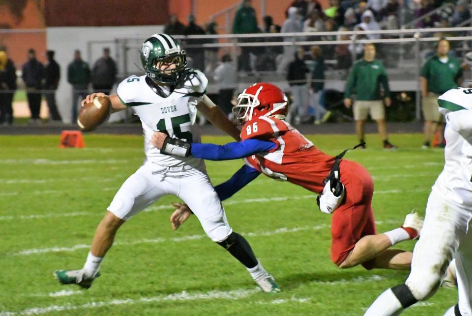 Dover junior quarterback Ryder Aubin looks to get off a throw before being sacked by a Spaulding defender during Week 4's game.