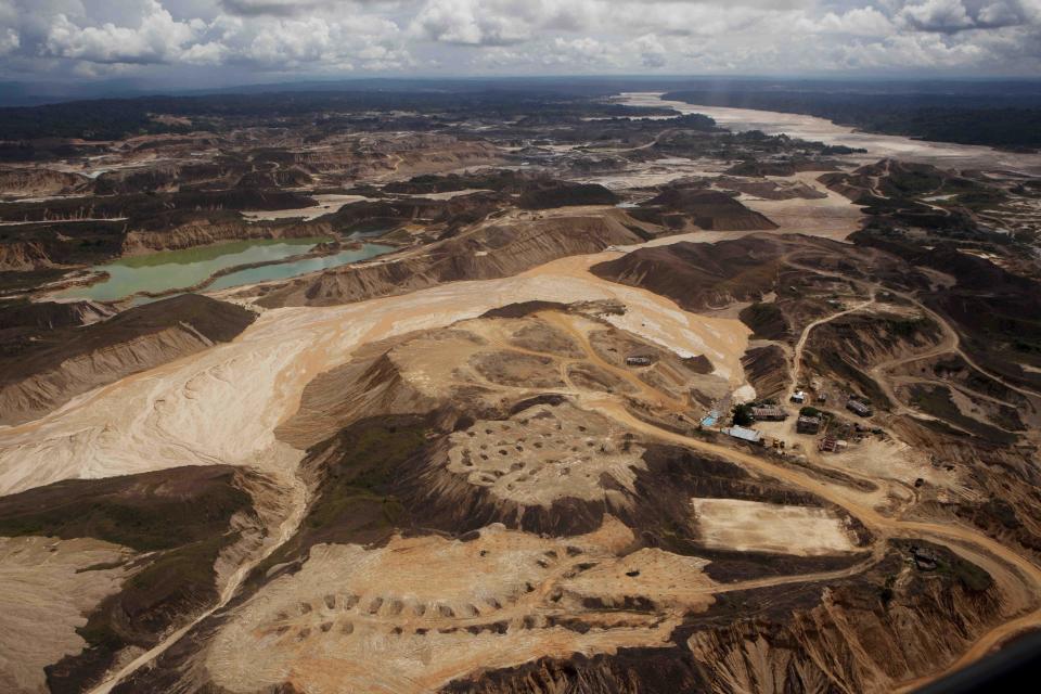 An aerial photo shows the scope of illegal mining in Huepetuhe district in Peru's Madre de Dios region in Peru, Monday, April 28, 2014. The mining uses tons of mercury and has ravaged forests and poisoned rivers. Authorities began enforcing a ban on illegal mining in the Huepetuhe district. They had given the state’s illegal miners until April 19 to get legal or halt operations. (AP Photo/Rodrigo Abd)