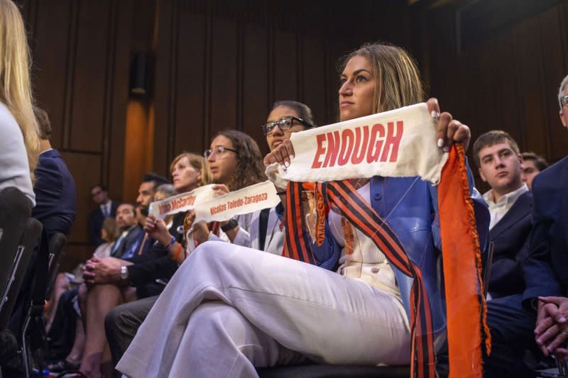 Rachel Jacoby, Stephanie Diaz and Allie Rubin, (L-R) students and community activists who attend school in Highland Park, Illinois, hold signs during a Senate Judiciary Committee hearing entitled 'After the Highland Park Attack: Protecting Our Committees from Mass Shootings' at the U.S. Capitol in Washington, DC in July 2022. A Fourth of July parade in Highland Park, where 7 were killed by a 21-year-old with an assault weapon, marked the 309th mass shooting in the United States in 2022. Photo by Bonnie Cash/UPI