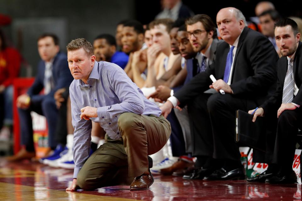 Eastern Illinois coach Jay Spoonhour, left, watches from the bench during the second half of the team's NCAA college basketball game against Iowa State, Friday, Dec. 21, 2018, in Ames, Iowa. Iowa State won 101-53.