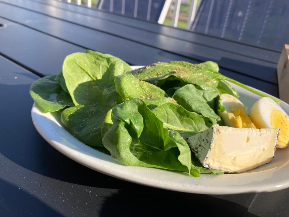 A spinach salad made with spinach grown at Sandy Bottom Farm in Isle La Motte, shown May 5, 2022 at the Kraemer & Kin taproom at Alburg Golf Links.