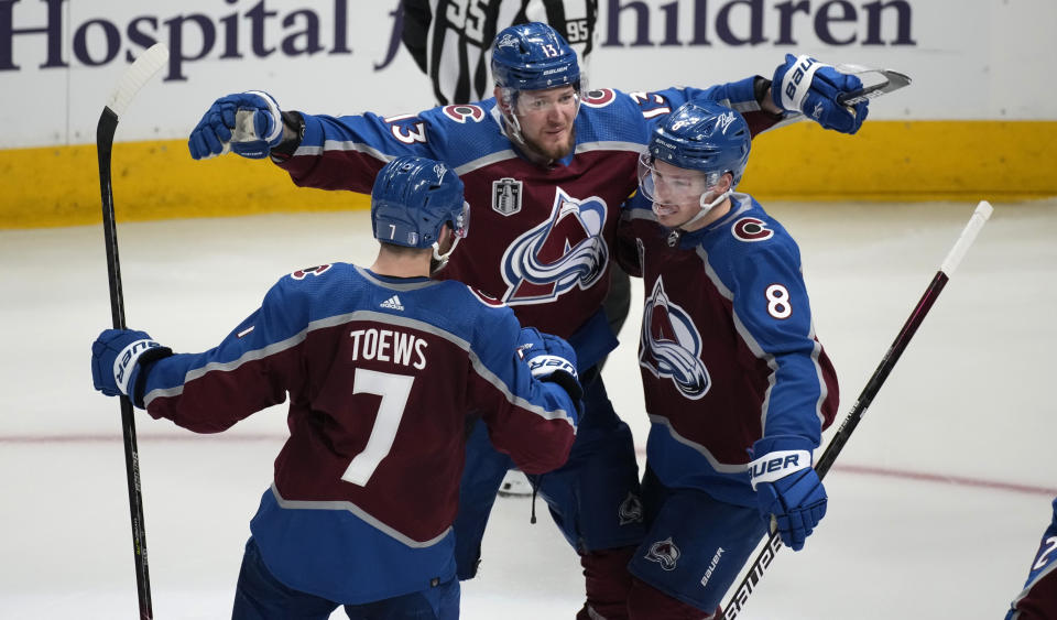 Colorado Avalanche defenseman Cale Makar, right, celebrates his goal against the Tampa Bay Lightning with right wing Valeri Nichushkin, center, and defenseman Devon Toews during the third period of Game 5 of the NHL hockey Stanley Cup Final, Friday, June 24, 2022, in Denver. (AP Photo/David Zalubowski)