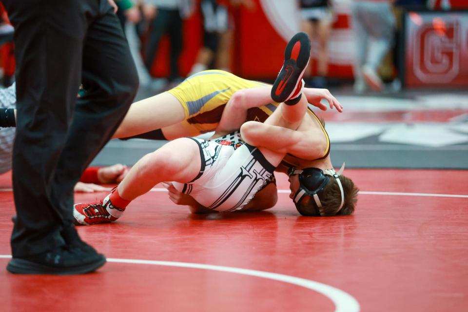 East Peoria freshman Cooper Chester pins Troy Triad's Shane Seip in the 113-pound title match at the Tyler Cox Memoria Invite at Chatham Glenwood on Saturday, Dec. 2.