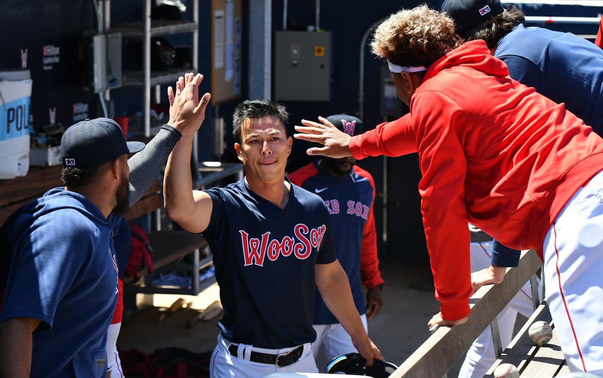 Worcester's Rob Refsnyder gets high-fives in the dugout after scoring on Ryan Fitzgerald's single during a game on May 11, 2022, at Polar Park.