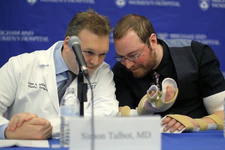 Will Lautzenheiser (R) talks to Dr. Simon Talbot, a member of his transplant team, at a news conference to announce Lautzenheiser's successful double arm transplant at Brigham and Women's Hospital in Boston, Massachusetts November 25, 2014. REUTERS/Brian Snyder