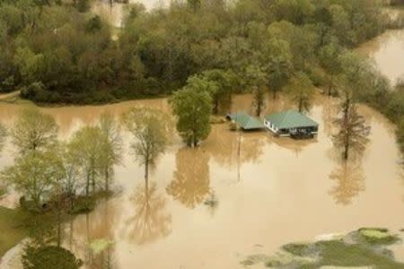 Floodwaters from heavy rains are seen in this aerial picture released by the U.S. Air National Guard photo in Ponchatoula, Louisiana taken March 12, 2016. Drenching rains this week have killed three people in Louisiana and one in Oklahoma. Picture taken March 12, 2016. REUTERS/U.S. Air National Guard/ Master Sgt. Toby M. Valadie/Handout via Reuters