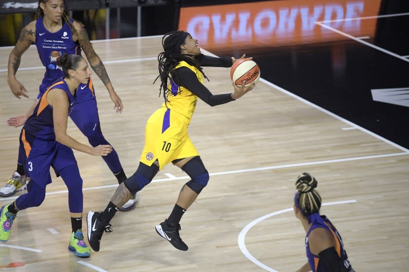 Los Angeles Sparks guard Tierra Ruffin-Pratt (10) goes up for a shot in front of Phoenix Mercury guard Diana Taurasi.