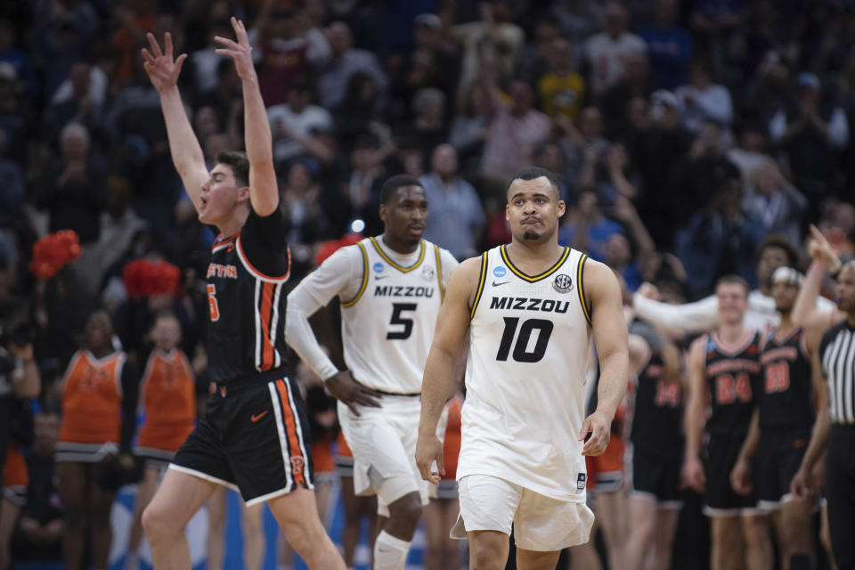 Missouri guard Nick Honor (10) and guard D'Moi Hodge (5) leaves the floor as Princeton guard Jack Scott (5) begins to celebrate following Princeton's victory in a second-round college basketball game in the men's NCAA Tournament, Saturday, March 18, 2023, in Sacramento, Calif. Princeton won 78-63. (AP Photo/José Luis Villegas)