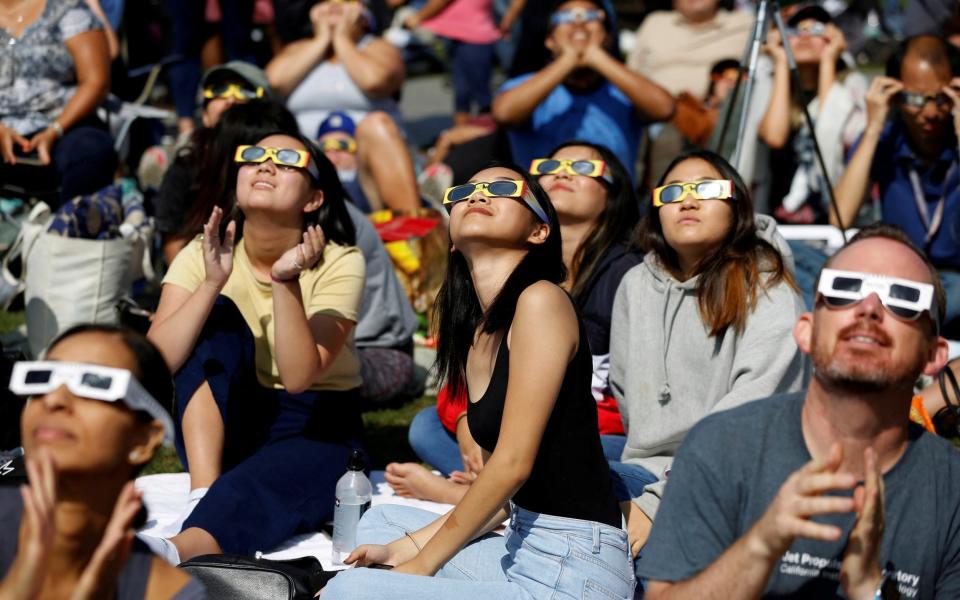 People watch the solar eclipse on the lawn of Griffith Observatory in Los Angeles in 2017