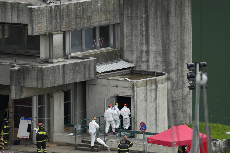 Fire fighters work at the scene of an explosion that occurred at the Enel Green Power hydroelectric plant at the Suviana Dam, some 70 kilometres southwest of Bologna, Italy, Wednesday, April 10, 2024. Search and rescue operations were still under way on Wednesday morning at a decades-old hydroelectric plant close to the northern Italian city of Bologna, after a devastating blast a day before killed at least three workers, injured five, and left four missing. Wednesday, April 10, 2024. (AP Photo/Antonio Calanni)