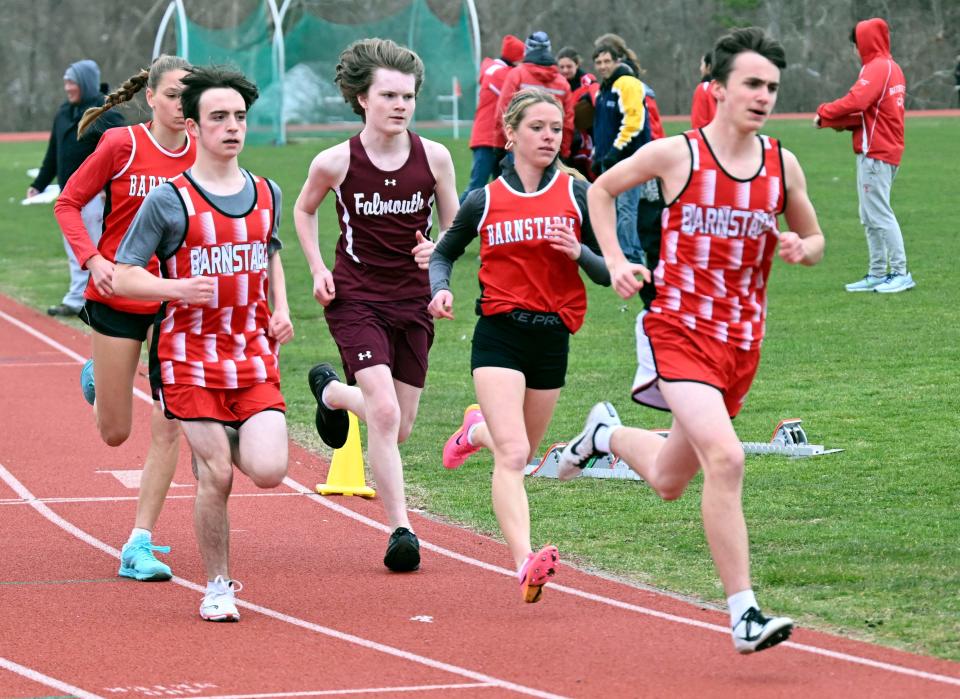 FALMOUTH   04/05/23 At the start of the 2 mile Kevin Defeudis (right) and Lilly DeDecko of  Barnstable lead the field against .  The two won the boys and girls event.  Falmouth track
