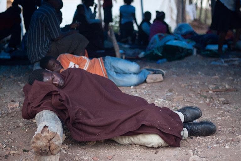 Zimbabwean nationals sleep in a tent at a support centre run by the International Organisation for Migration in Beitbridge, Zimbabwe, on April 21, 2015 after being repatriated fearing xenophobic attack in South Afric