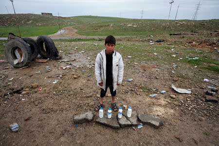 A boy sells milk on the street near the city of Mosul, Iraq March 18, 2017. REUTERS/Youssef Boudlal