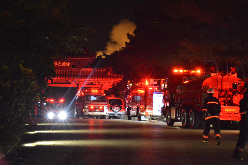 Fire engines line up in front of Shureimon gate leading to Shuri Castle as smoke rises in the background, in Naha, Okinawa, southern Japan, Thursday, Oct. 31, 2019. A fire broke out at the historic Shuri Castle on Japan’s southern island of Okinawa, nearly destroying it. (Tomomi Tomita/Kyodo News via AP)