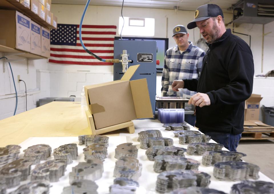 Partners KIrk Hyust,right, and Brian Halasinski package Turbo Trussers in their Plain Township work space.