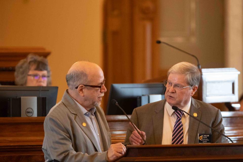 Rep. Vic Miller, D-Topeka, right, replys to Rep. Tom Sawyer,D-Wichita, left, on why he was left out of discussions on his amendment to a tax cut bill put forth Tuesday during the special session.