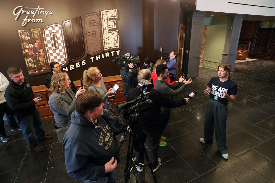 Katherine Reedy, lead deisgner of House Three Thirty, greets local media members in the foyer before a tour of the new House Three Thirty Wednesday in Akron.