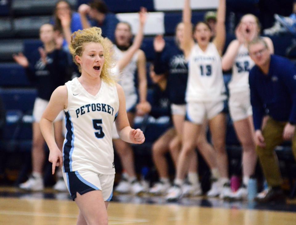 Petoskey's Hope Wegmann runs back on defense fired up, as her teammates cheer on her 3-pointer in the first half against Alpena Friday.