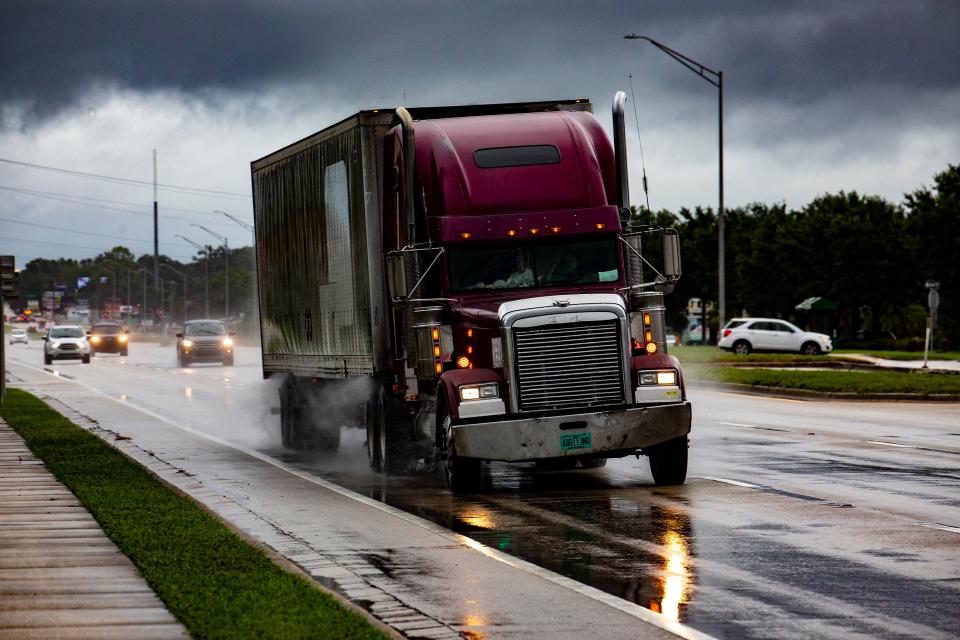 Trucks and cars drive along a rainy U.S. 98 North as rain bands from Hurricane Idalia swirl overhead in Lakeland on Wednesday.