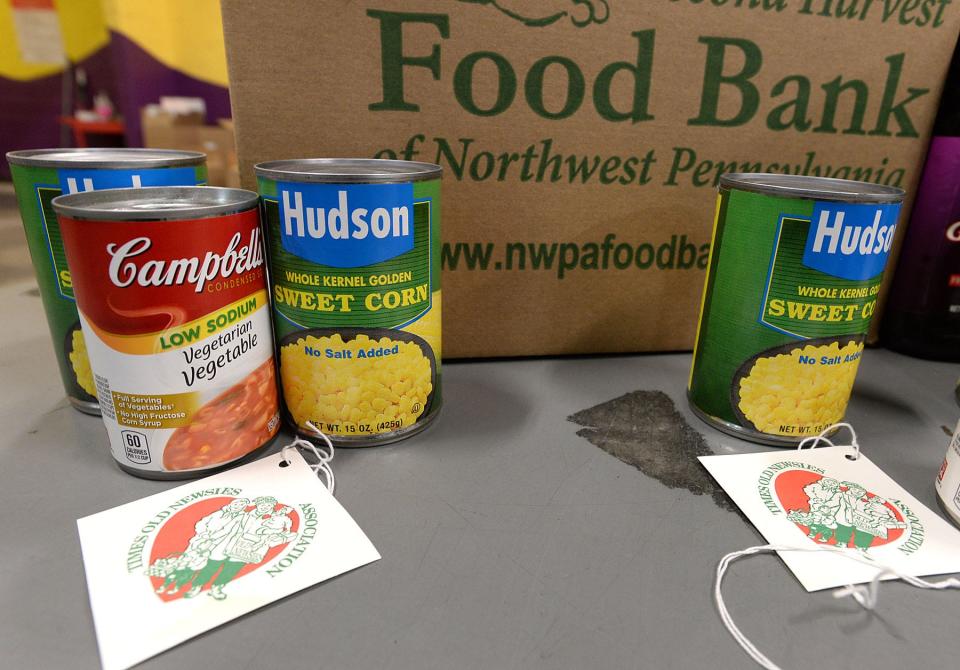 Canned goods and boxes of cereal are placed in boxes by Old Newsies on Nov. 19, 2020 at the Second Harvest Food Bank of Northwest Pennsylvania.