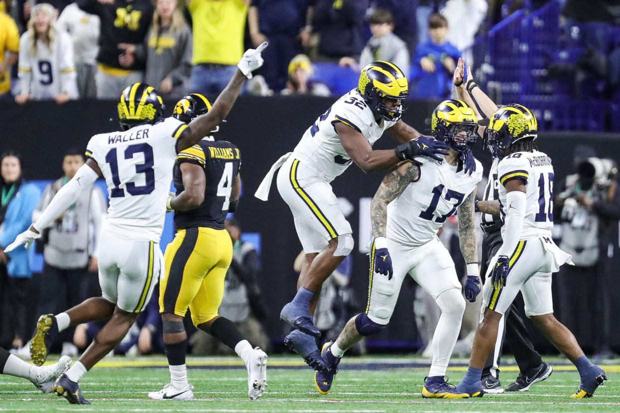 Michigan defensive end Braiden McGregor (17) and defensive end Jaylen Harrell, center, celebrate a play during the second half of U-M's 26-0 win over Iowa in the Big Ten championship game in Indianapolis on Saturday, Dec. 2, 2023.