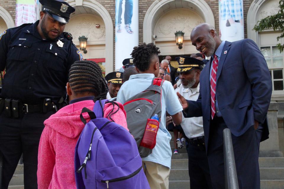 Red Clay school district superintendent Dorell Green, right, greets students on the first day of school at Warner Elementary School on Aug. 26, 2019