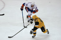 Pittsburgh Penguins' Sidney Crosby (87) skates with the puck past New York Islanders' Brock Nelson (29) during the third period of an NHL hockey game Saturday, March 27, 2021, in Pittsburgh. (AP Photo/Keith Srakocic)