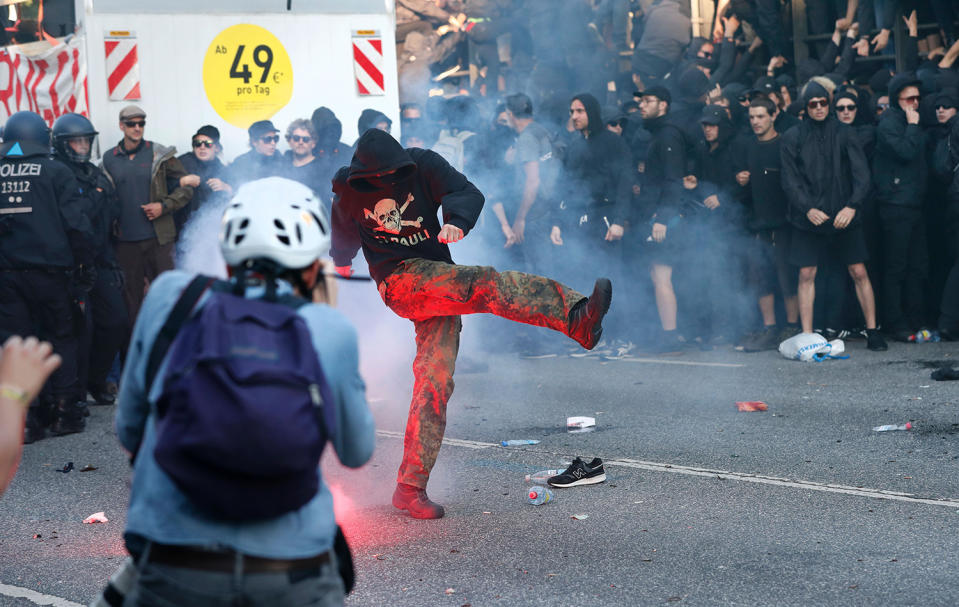 <p>Flares are thrown at Riot police during the “Welcome to Hell” rally against the G-20 summit in Hamburg, northern Germany on July 6, 2017. (Photo: Odd Andersen/AFP/Getty Images) </p>