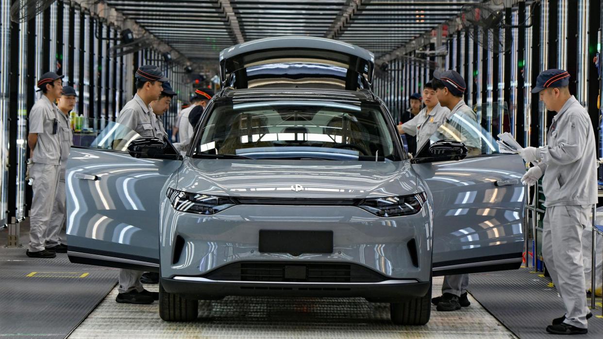 Employees work on the assembly line of new energy vehicles at a factory of Chinese EV startup Leapmotor.