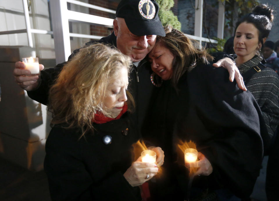 Chef John Kaufmann, center, consoles Chef Priscila Satkoff, right, and Jamie Pellar, left, during a candlelight memorial for Chicago Chef Charlie Trotter outside his former restaurant Tuesday, Nov. 5, 2013, in Chicago. Trotter, 54, died Tuesday, a year after closing his namesake Chicago restaurant that was credited with putting his city at the vanguard of the food world and training dozens of the nation's top chefs, including Grant Achatz and Graham Elliot. (AP Photo/Charles Rex Arbogast)