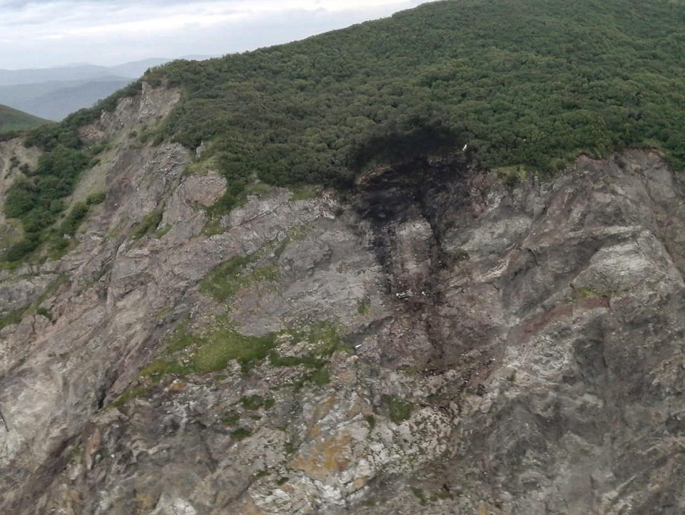 This photo released by the Russia Emergency Situations Ministry press service on Wednesday, July 7, 2021, shows wreckage of a missing Antonov An-26 missing plane found near its destination airport outside the town of Palana, in Russia's Far East. The plane carrying 28 people crashed Tuesday, apparently as it came in for a landing in bad weather in Russia’s Far East, and everyone aboard was feared dead. (Russia Emergency Situations Ministry press service via AP)