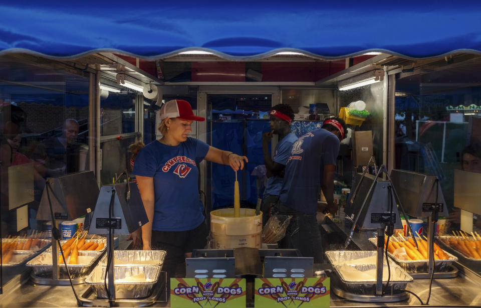 Employees of Campbell&rsquo;s food stand prepare a corndog for the deep-fryer Sunday, Aug. 11, 2019. The Iowa State Fair is known for its corndogs and politicians. (Photo: Seth Herald for HuffPost)