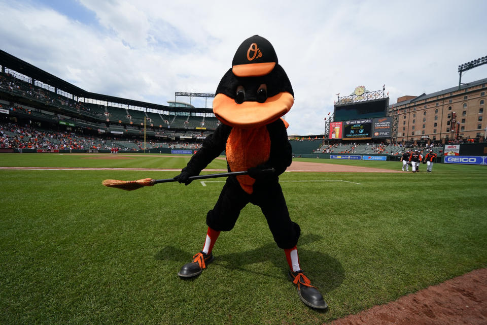 The Oriole Bird holds a broom after the Baltimore Orioles defeating the Los Angeles Angels 9-5 during a baseball game to complete a series sweep, Sunday, July 10, 2022, in Baltimore. (AP Photo/Julio Cortez)