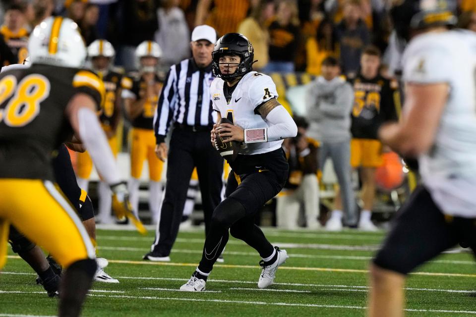 Appalachian State Mountaineers quarterback Joey Aguilar looks to throw against the Wyoming Cowboys during the fourth quarter at Jonah Field at War Memorial Stadium.