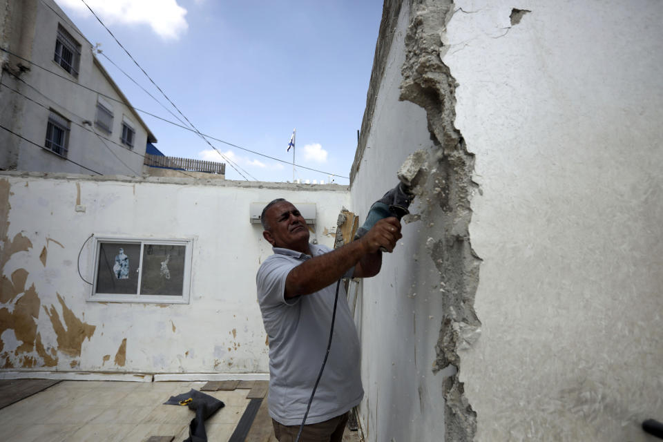 In this Monday, Sept. 9, 2019 photo, Palestinian Jamil Masalmeh uses a power tool to destroy an apartment he had added to his home years earlier, in the Silwan neighborhood of east Jerusalem. When he failed to secure a permit, Israeli municipal authorities gave him the option of destroying it himself or paying more than $20,000 for the city to demolish it. New data shows a spike in Jewish settlement construction in Israeli-annexed east Jerusalem since President Donald Trump took office and a huge, decades-old gap in the number of building permits granted to Jewish and Palestinian residents. (AP Photo/Mahmoud Illean)