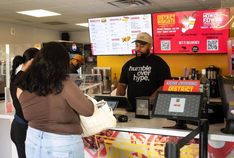 Dwight Tiller takes a lunch order from customers on Wednesday, Sept. 4, at District Biskuits in North Kansas City. The restaurant, which opened in 2022, specializes in biscuit sandwiches.