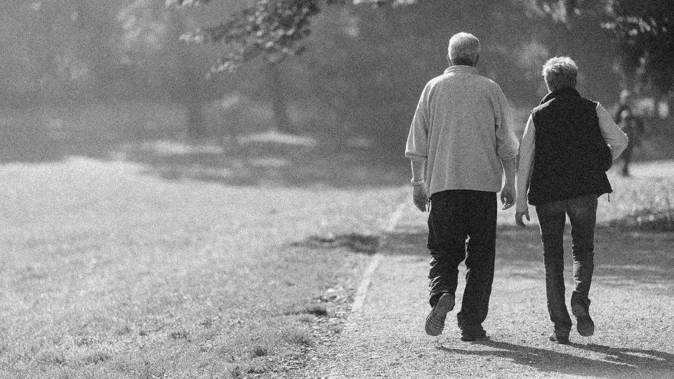 happy retired couple on a walk together in the park