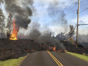 <p>In this Saturday, May 5, 2018, photo provided by the U.S. Geological Survey, lava from Fissure 7 slowly advances to the northeast on Hookapu Street in the Leilani Estates subdivision in Pahoa, Hawaii. (Photo: U.S. Geological Survey via AP) </p>